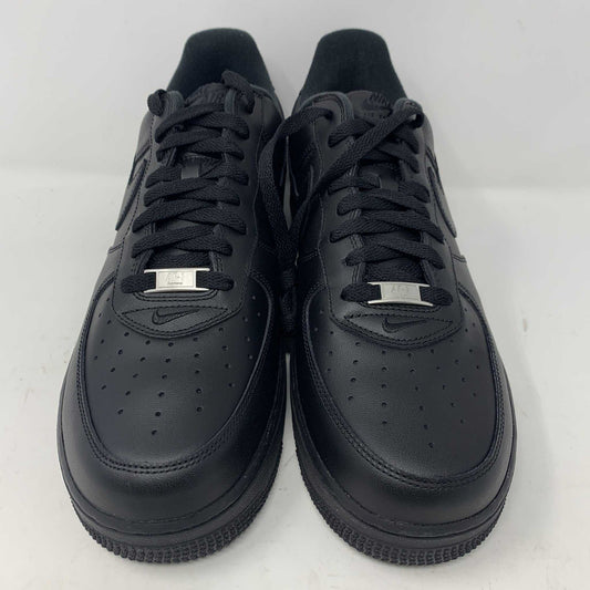 The Nike Supreme Air Force 1 Black features a perforated design on the toe box, black supreme laces with a shiny tag, and a prominent Nike logo, all set against a plain white background.