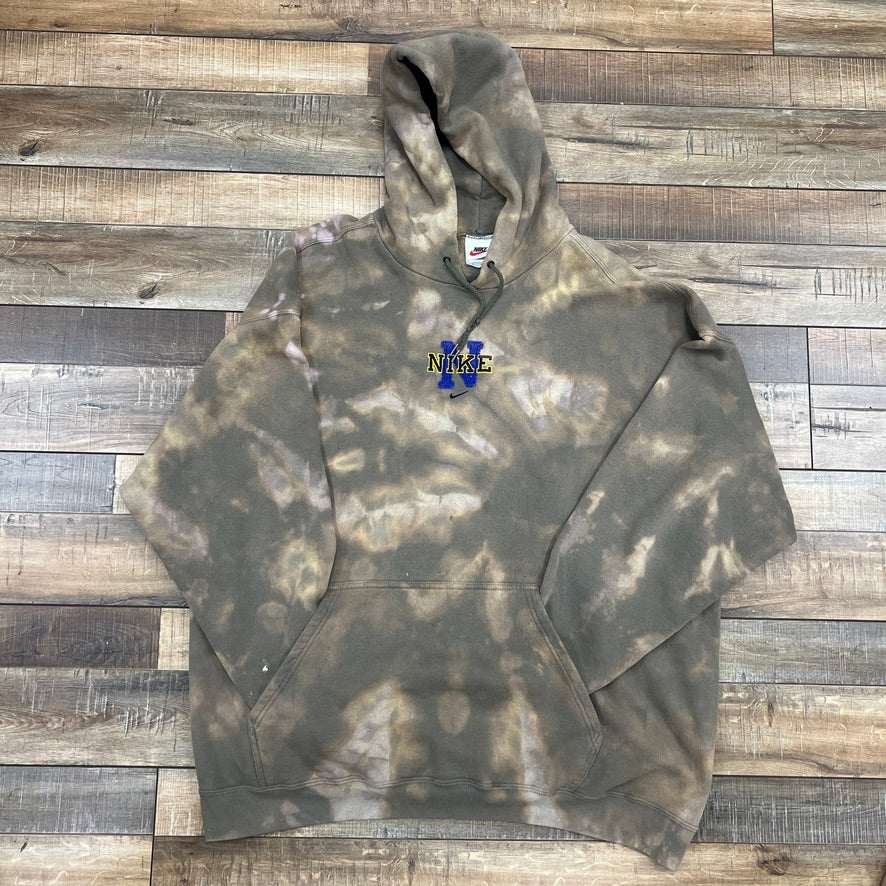 Nike Logo Center Swoosh Hoodie, preowned, tie-dye style, on wooden floor.
