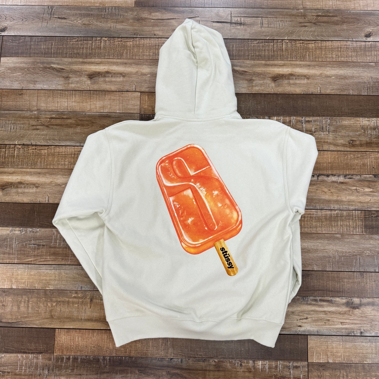 Stussy Popsicle Hoodie Stone preowned on wooden floor.
