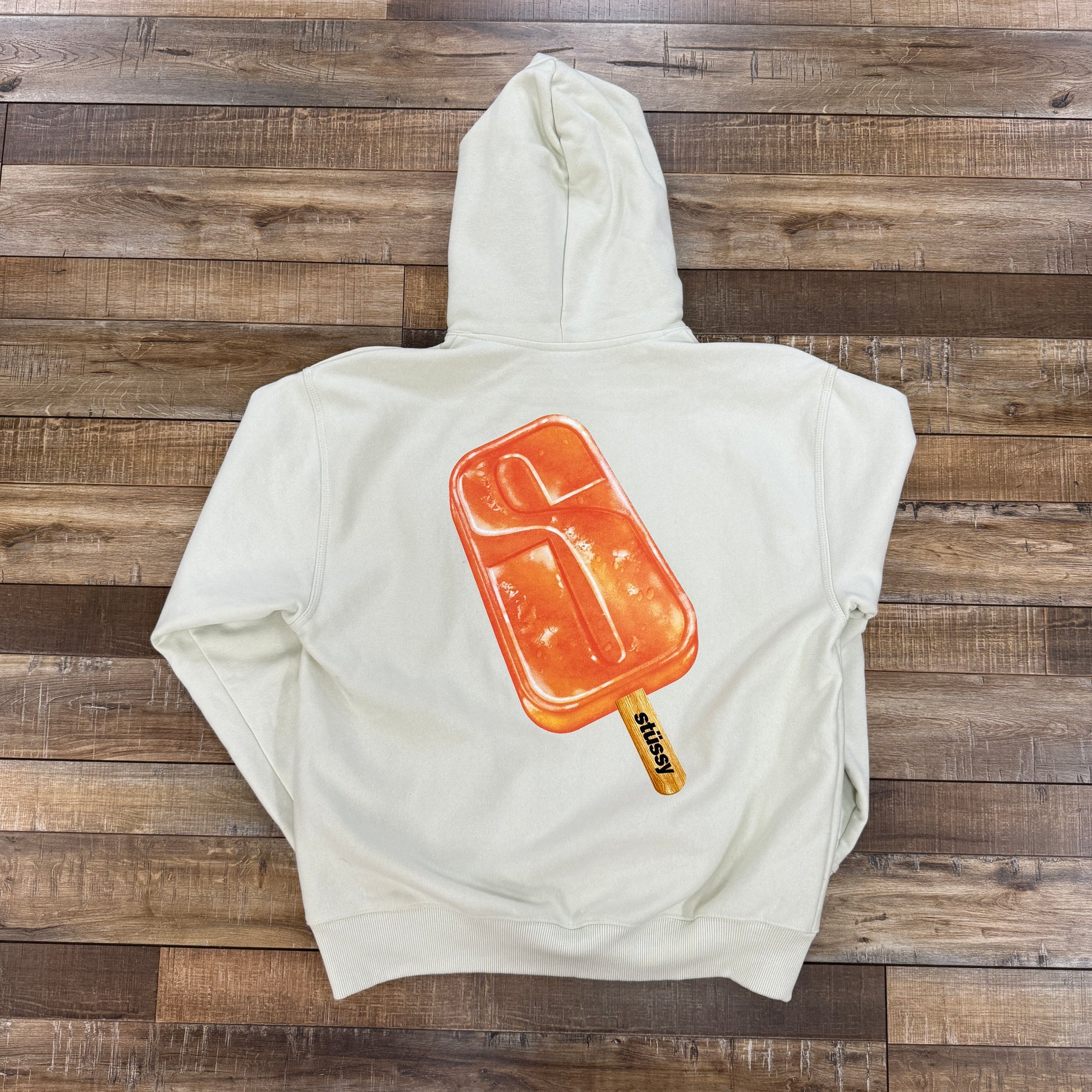 Stussy Popsicle Hoodie Stone preowned on wooden floor.
