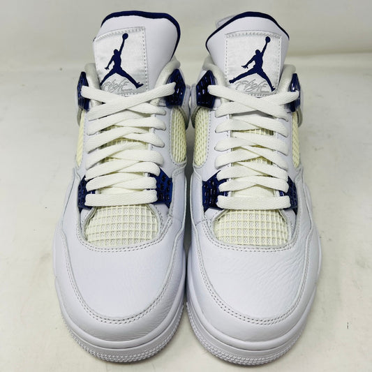 The Jordan 4 Retro Metallic Purple sneaker features white material with blue mesh accents, a visible air cushion in the heel, textured sole, angular overlays, and a padded collar. Note: no box included.