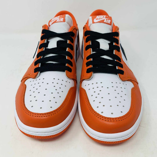 A pair of BRAND NEW Jordan 1 Low Starfish sneakers is displayed, viewed from the front. The orange and white shoes have black laces, a perforated white toe box, and the 100% Authentic Jordan logo is visible on the tongue.