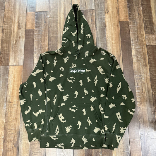 Supreme Box Logo Hooded Sweatshirt FW21 Olive Russian Camo brand new on wooden floor.