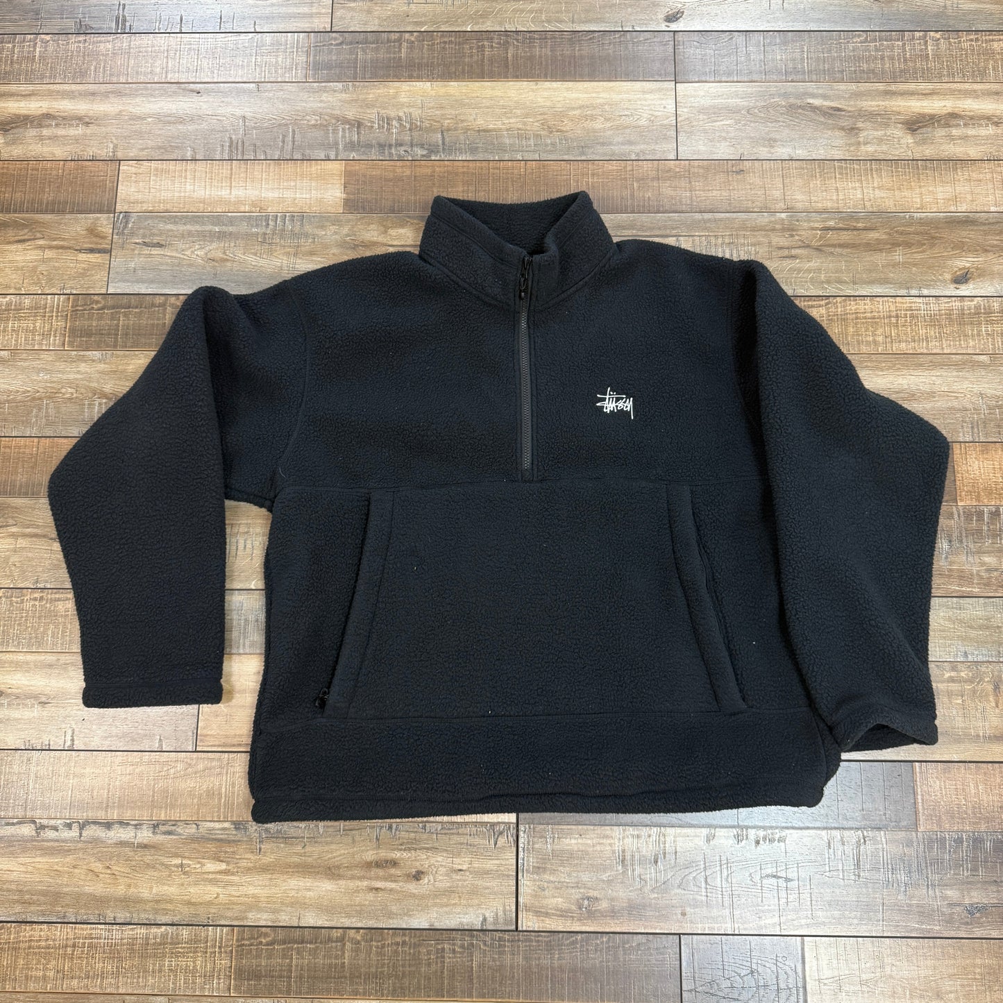 Stussy Polar Fleece Half Zip Black preowned sweater on wooden floor.