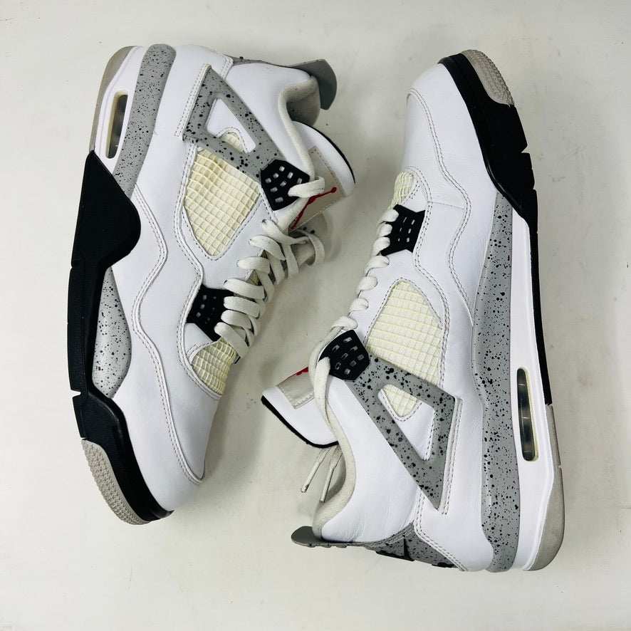 A size 13 Jordan 4 Retro White Cement (2016) sneaker by Jordan is shown on its original black speckled box with an Air Jordan logo. The shoe features clean white uppers with gray and black accents, representing the classic 2016 style.
