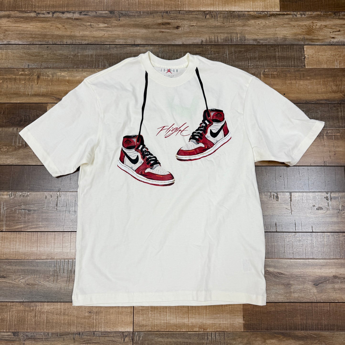 White Jordan 1985 Lost and Found men's short sleeve shirt with graphic of red and black sneakers and word "Flight" on front
