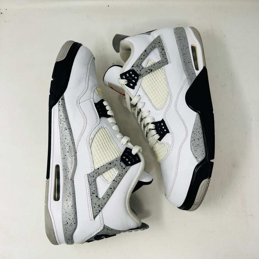 A size 13 Jordan 4 Retro White Cement (2016) sneaker by Jordan is shown on its original black speckled box with an Air Jordan logo. The shoe features clean white uppers with gray and black accents, representing the classic 2016 style.