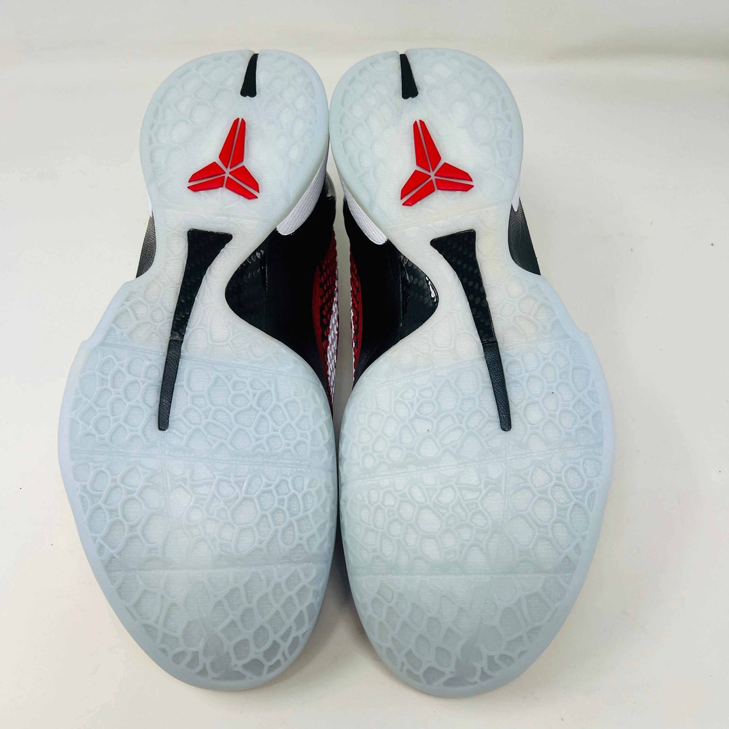 A brand new Kobe Nike Kobe 6 Protro Challenge Red All-Star (2021) sneaker, with a textured pattern and white swoosh, is showcased on a black shoebox. The authentic shoe has a black and white sole, red laces, and ZOOM on the side of the sole.