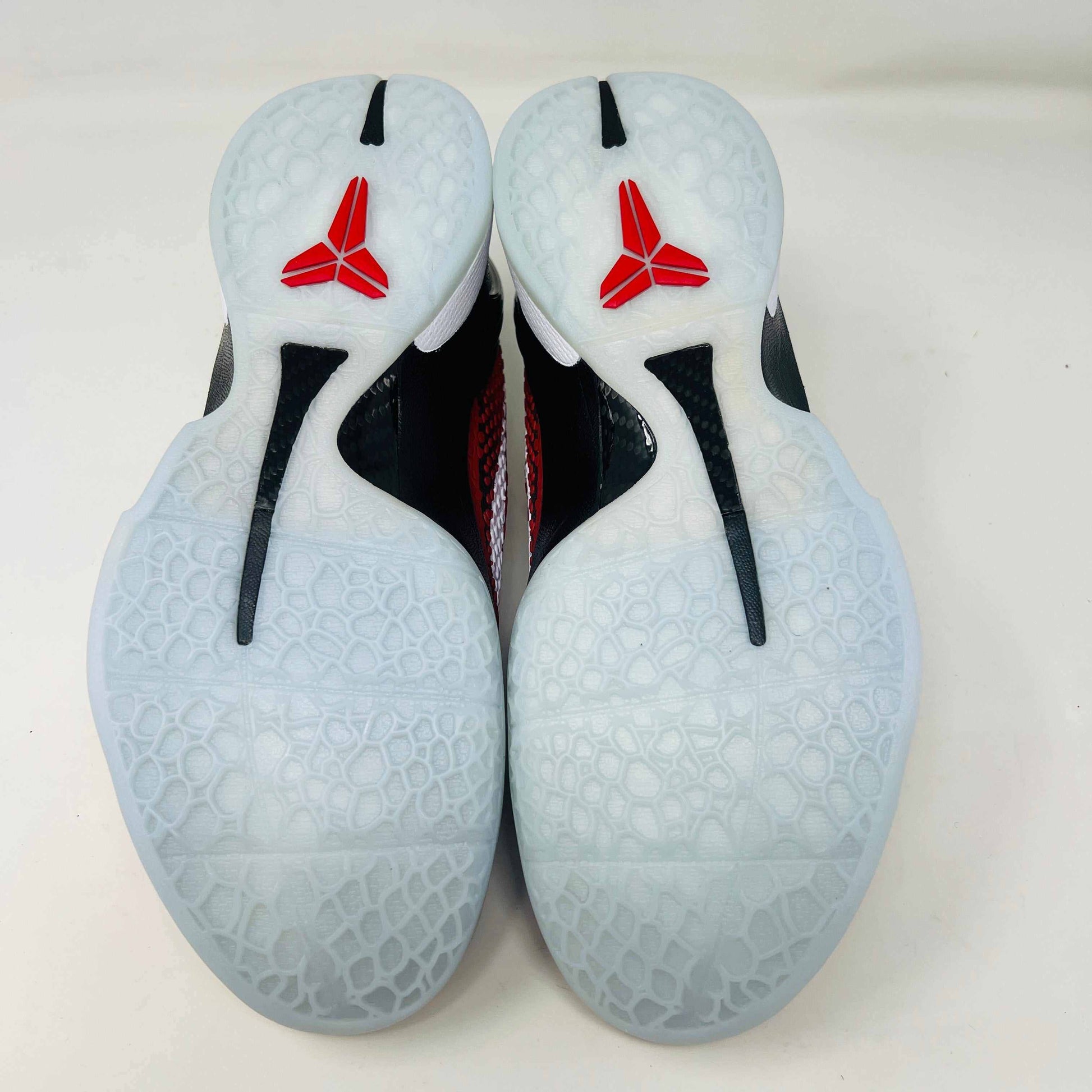A brand new Kobe Nike Kobe 6 Protro Challenge Red All-Star (2021) sneaker, with a textured pattern and white swoosh, is showcased on a black shoebox. The authentic shoe has a black and white sole, red laces, and ZOOM on the side of the sole.
