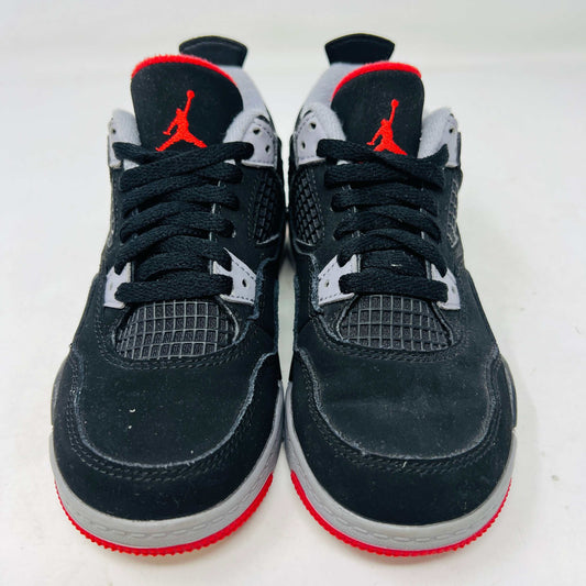 The Jordan 4 Retro Bred (2019) (PS) in black and red, featuring clean uppers with a white midsole and gray accents, sits on its original black shoebox. The box displays size, product details, and the iconic Jumpman logo, underscoring these authentic shoes from Jordans 2019 collection.