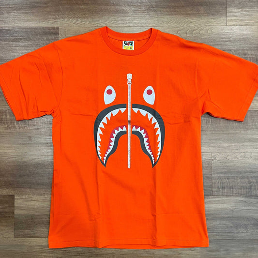 A BATHNIG APE Men's SHARK TEE in orange, size XL, brand new condition.