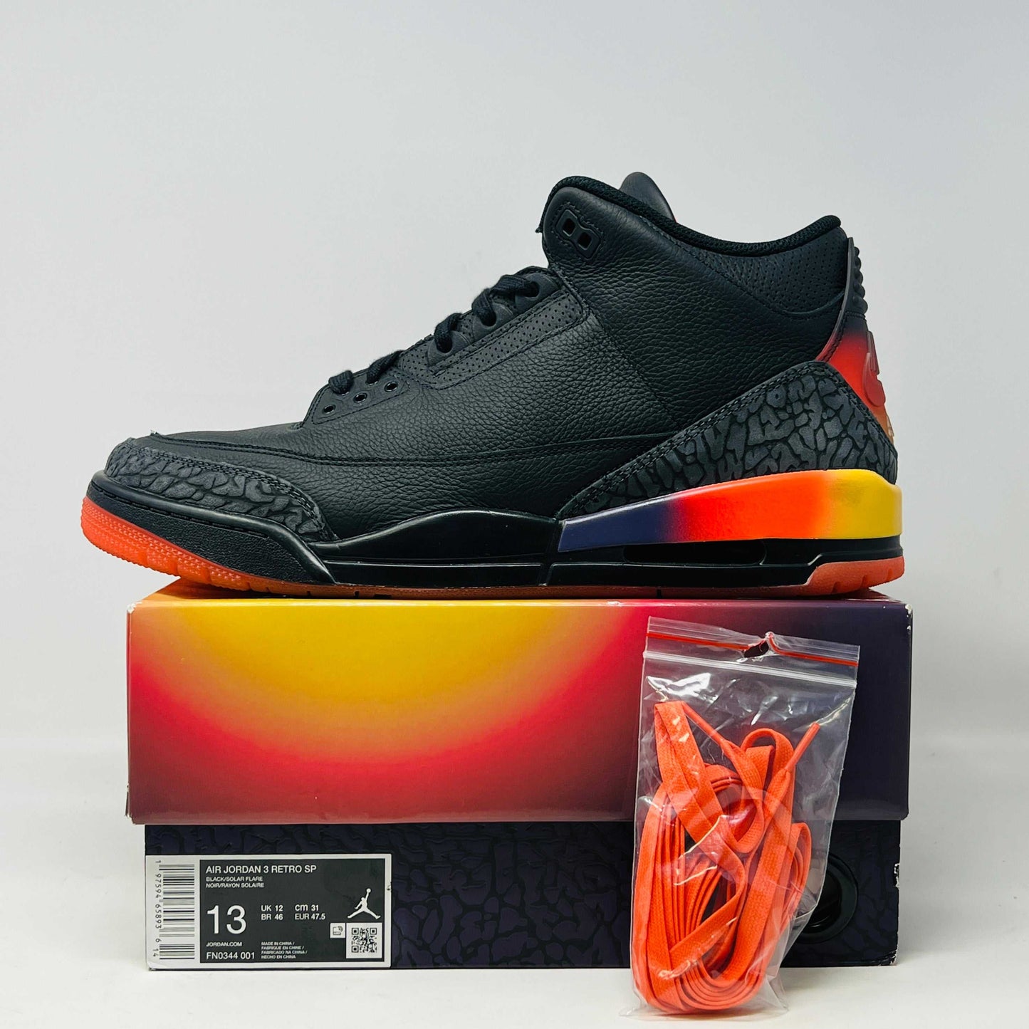 Jordan 3 Retro J Balvin Rio sneakers with vibrant design, displayed with packaging and orange laces.