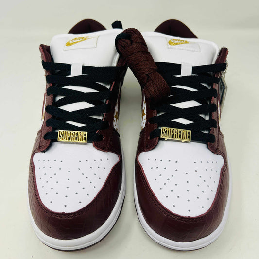 Introducing the new Nike SB Dunk Low Supreme Barkroot sneakers by Nike, featuring a star pattern with a World Famous Supreme tag and housed in a striking purple Nike SB box.