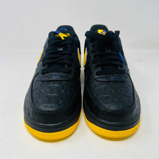 Brand new Nike Air Force 1 Low Kobe Bryant Lakers Away sneaker in black with yellow and blue accents, featuring embossed details. Displayed on a white box with a yellow Nike logo and Kobe Bryant symbol. Limited edition of 8000, ideal for those seeking standout accessories.