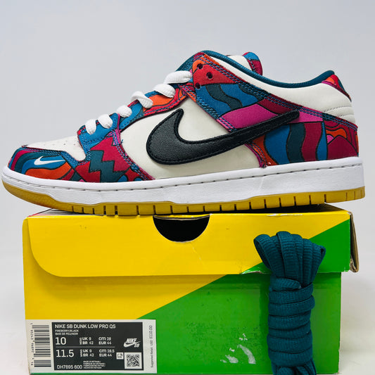 The Nike SB Dunk Low Pro Parra Abstract Art (2021) features a colorful design with abstract red, blue, and purple patterns on a white base. It includes clean uppers with a black swoosh, white laces, and comes in a green/yellow box with extra blue laces for added versatility.
