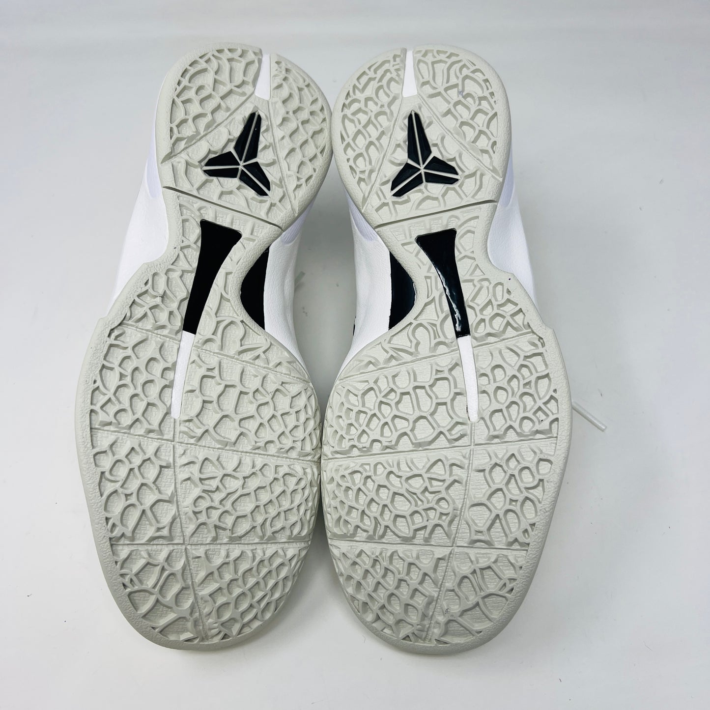 The fresh white Nike Kobe 6 Sail All-Star (GS) athletic shoe, showcasing a textured design and black swoosh logo, is presented on an orange box. Inside are plastic-wrapped accessories and extra laces for versatile style in 2024.