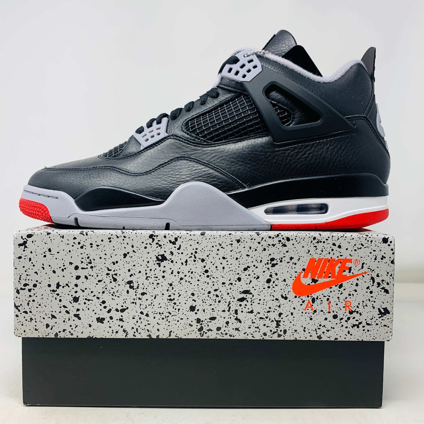 Jordan 4 Retro Bred Reimagined sneaker with black hangtag, 2024 model, brand new condition.