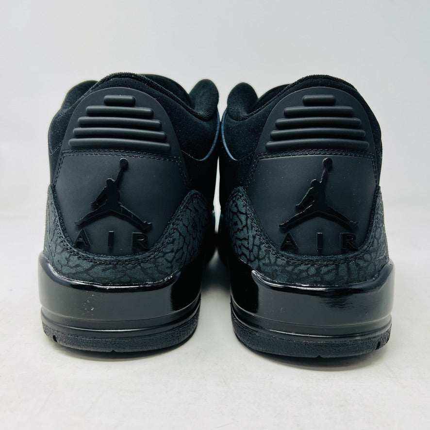 The Jordan 3 Retro Black Cat (2025) sneaker, featuring a glossy finish and elephant print accents, sits on a black box with the red Jumpman logo. This brand new, 100% authentic release from Jordan ensures style and exclusivity.
