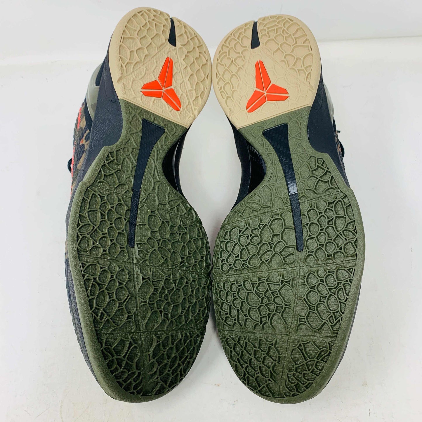 The 2024 Nike Kobe 6 Protro Italian Camo features a textured gray upper with a bright red swoosh, sits on a black shoe box, and has a greenish midsole labeled Zoom. The sleek black lace system completes this authentic sporty sneaker.