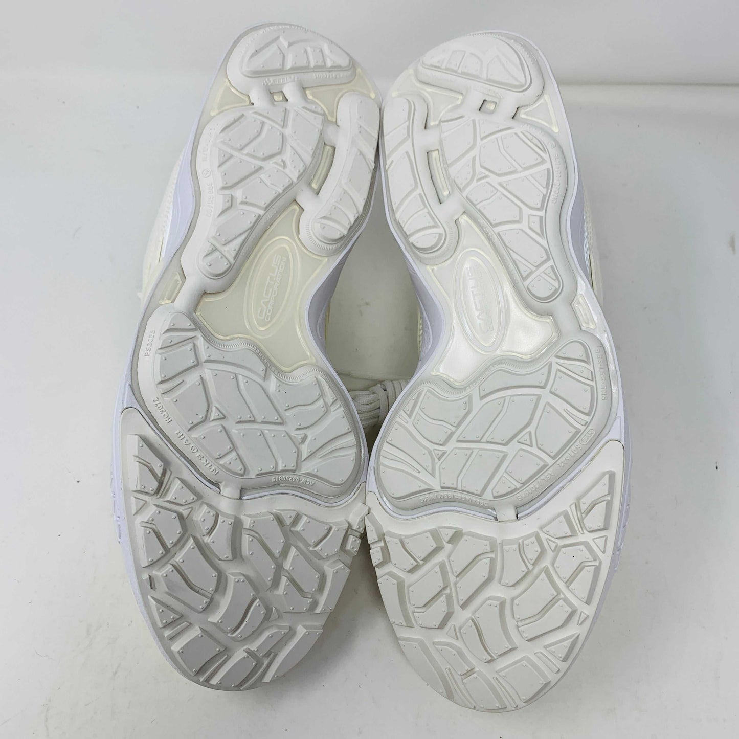 A pair of brand new, 100% authentic Nike Zoom Field Jaxx SP Travis Scott Sail sneakers feature a white colorway with a textured design and lace-up closure. The shoes, shown on a white background, have a thick sole and combine smooth and perforated panels.