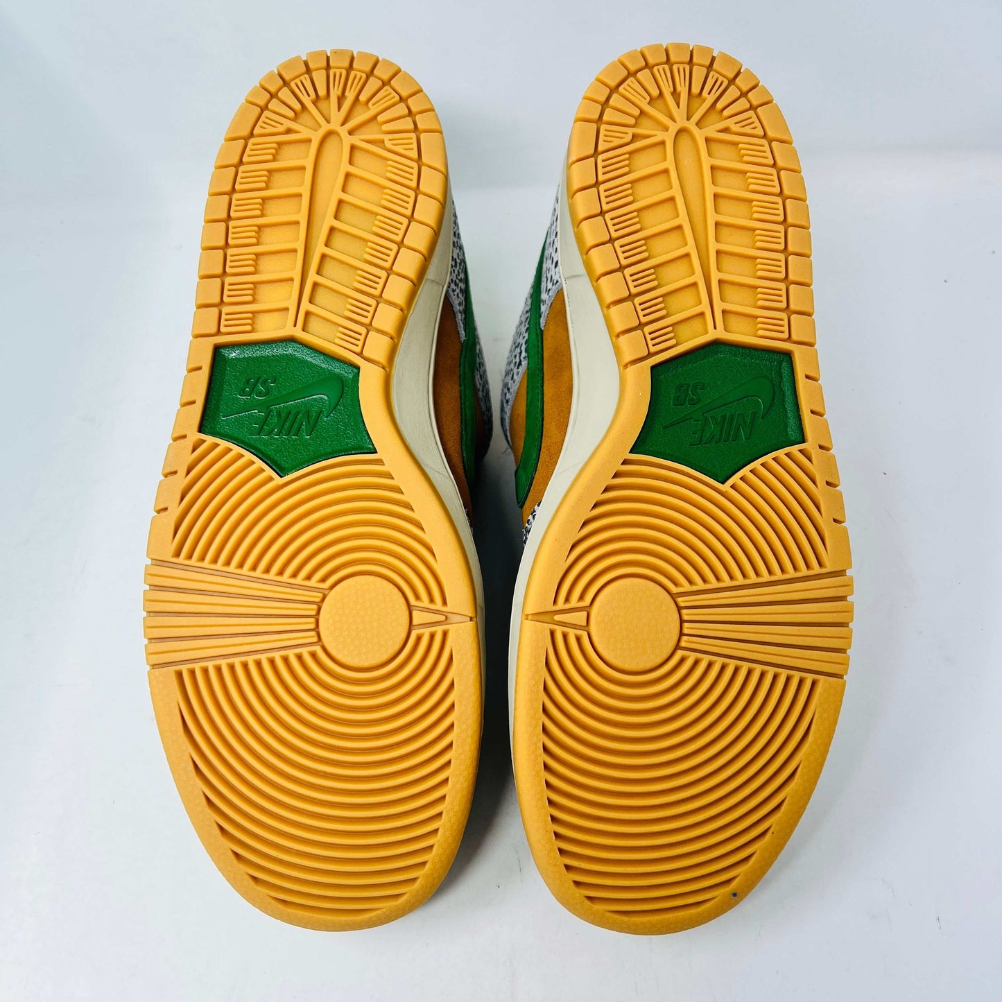 Nike SB Dunk Low Safari sneakers with orange soles and green accents, 2020 release.