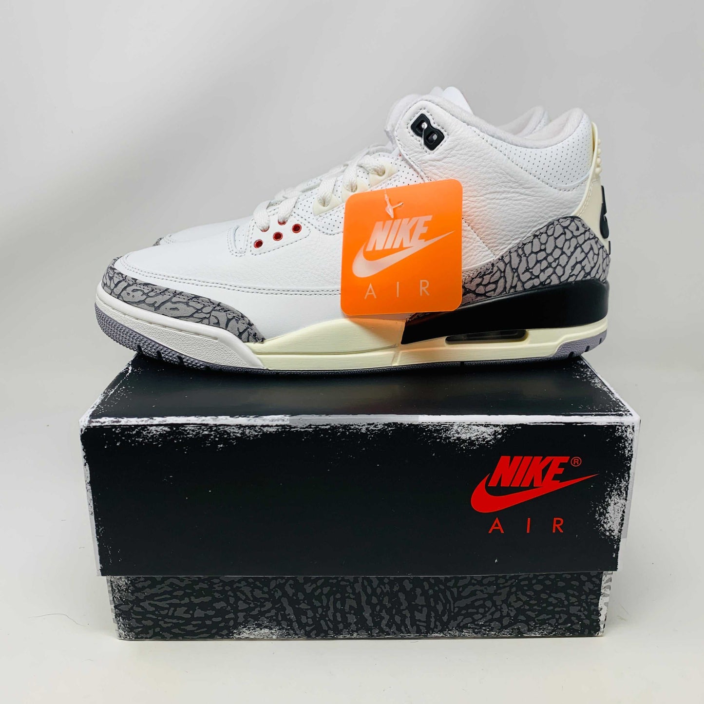 Jordan 3 Retro White Cement Reimagined sneaker, brand new, 2023 release, with hang tag, on Nike Air box.