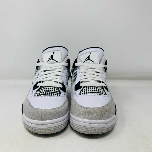 The Jordan 4 Military Black GS sneakers, featuring distinctive side netting and a logo on the tongue, are brand new and authentic in white and gray with black accents. They face forward on a white surface against a plain background, embodying modern style.