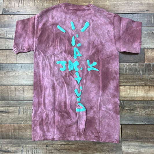 The Travis Scott x McDonalds Jack Smile II T-shirt in Berry by Cactus Jack is a purple tie-dye featuring a man in a cap and the text Tell Em Jack Sent You, accented with a large red C, yellow M, small US, and black-and-white patterns, offering an authentic, eye-catching design.