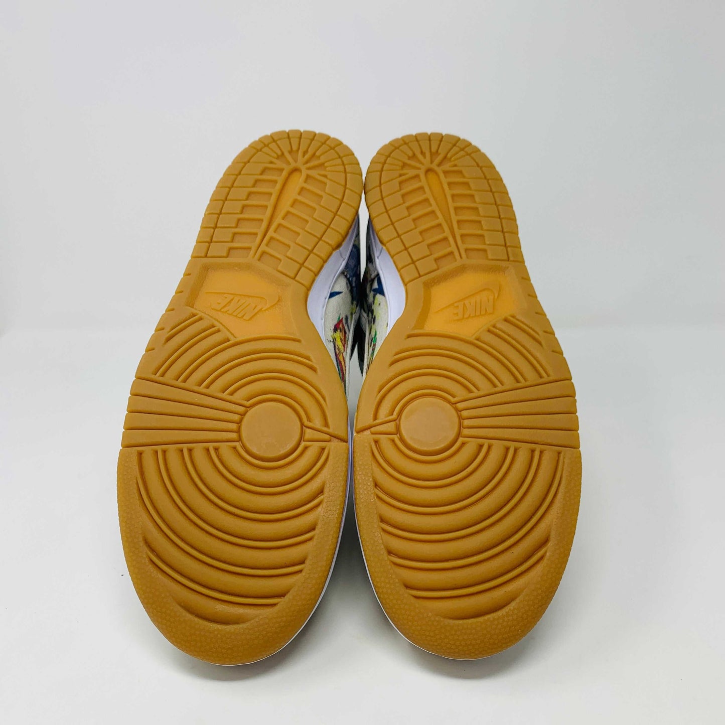 The Nike SB Dunk High Supreme Rammellzee, a 2023 release, sports a vibrant, abstract design. It features an off-white upper with a gum sole and sits atop a Nike SB shoe box. A World Famous tag affirms authenticity, making it ideal for collectors and enthusiasts.