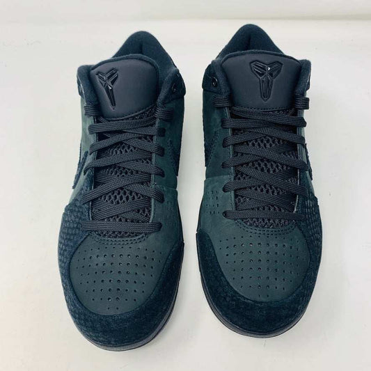 A brand new Nike Kobe 4 Protro Gift of Mamba sneaker in black, featuring a textured design with glossy and matte elements and prominent swoosh logo, is showcased atop its matching shoebox. Distinct patterns on the side and heel capture the essence of 2023s authentic shoe style.