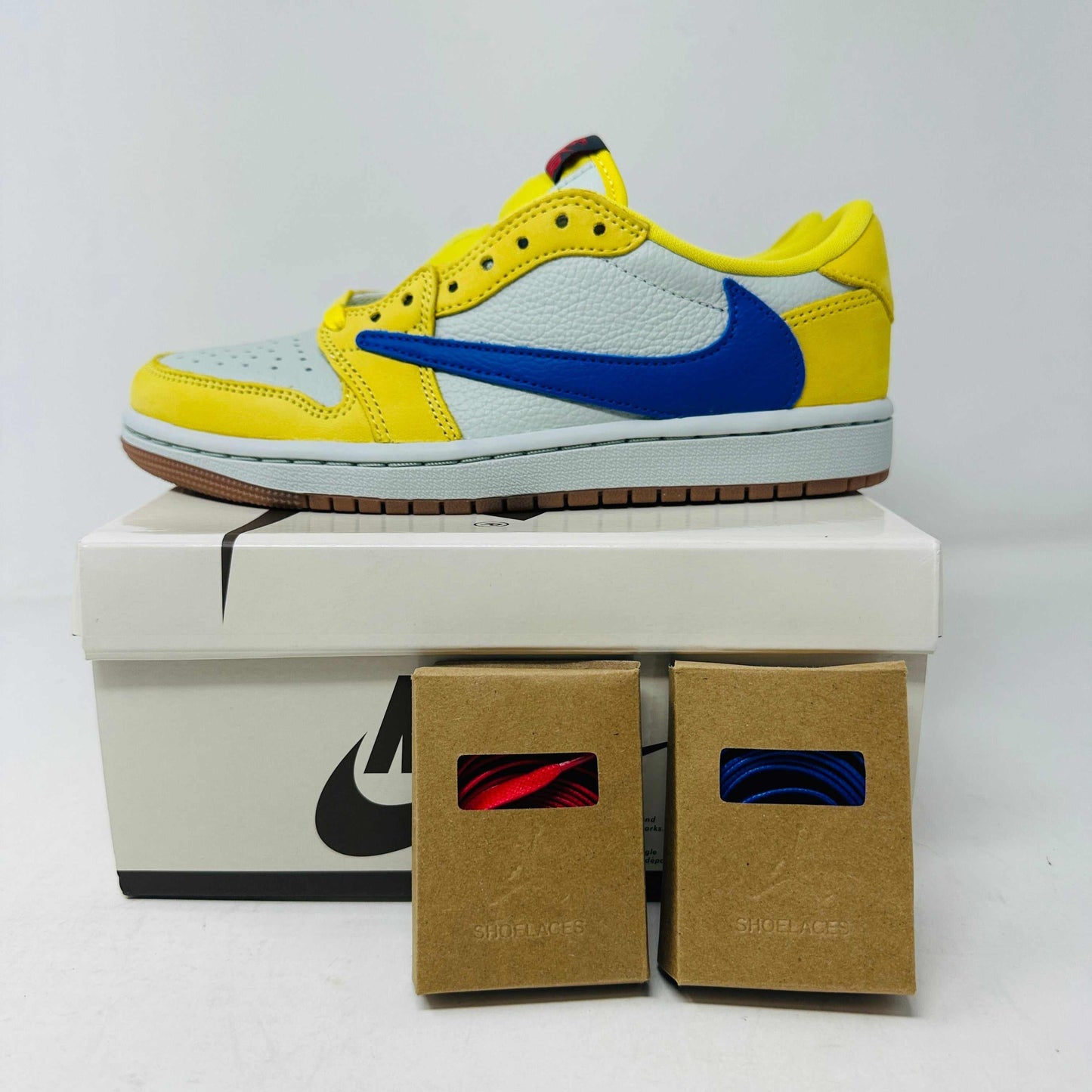 Jordan 1 Retro Low OG SP Travis Scott Canary Women's sneaker with extra laces, brand new condition, 2024 edition.