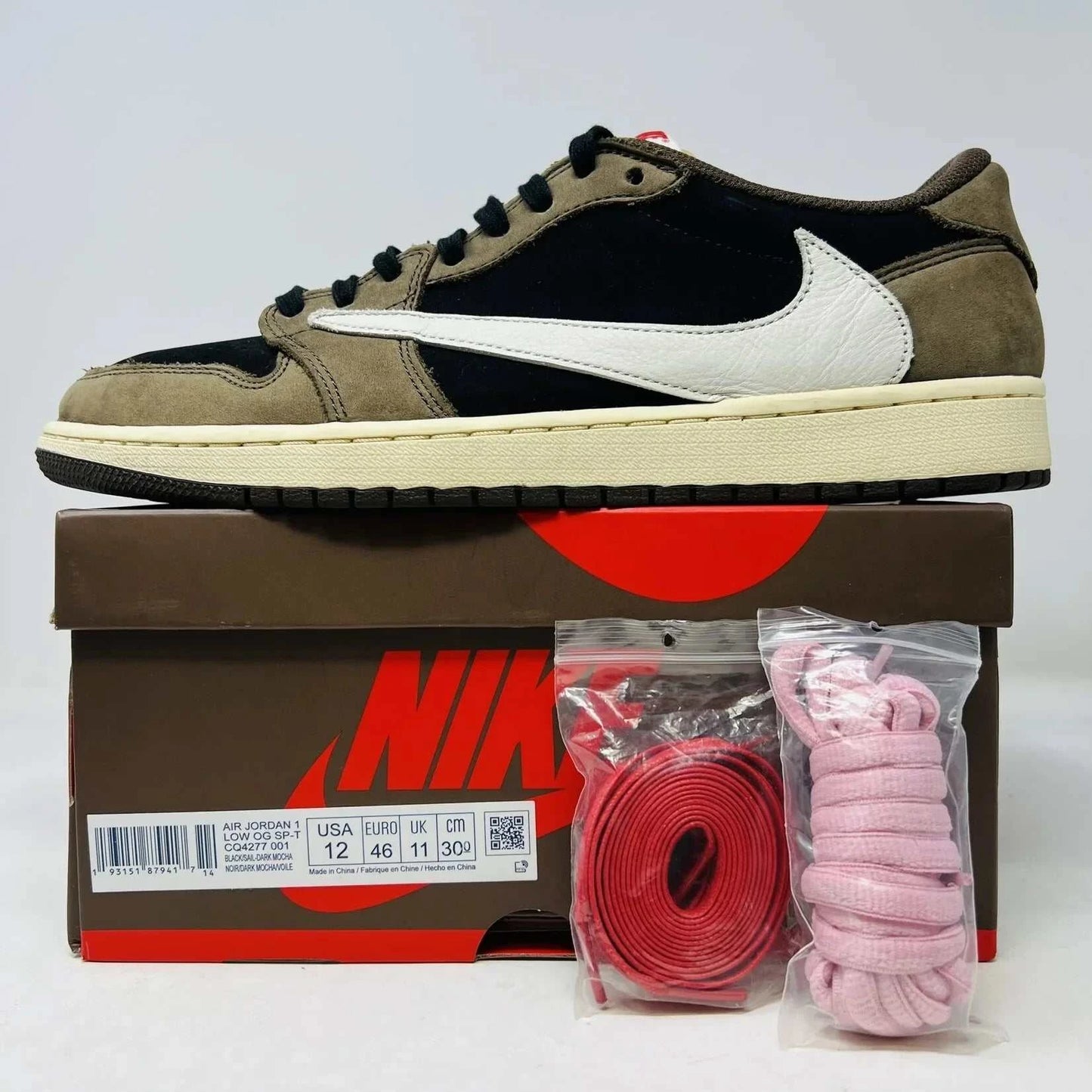 Jordan 1 Retro Low OG SP Travis Scott Mocha sneakers with extra pink and red laces.