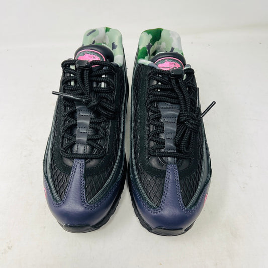Introducing the Nike Air Max 95 SP Corteiz Pink Beam, black sneakers with textured design and purple accents. They feature a pink logo on the tongue, green and gray camo inner lining, black laces with toggle fasteners, fitting perfectly into 2021 fashion trends; available without a box.