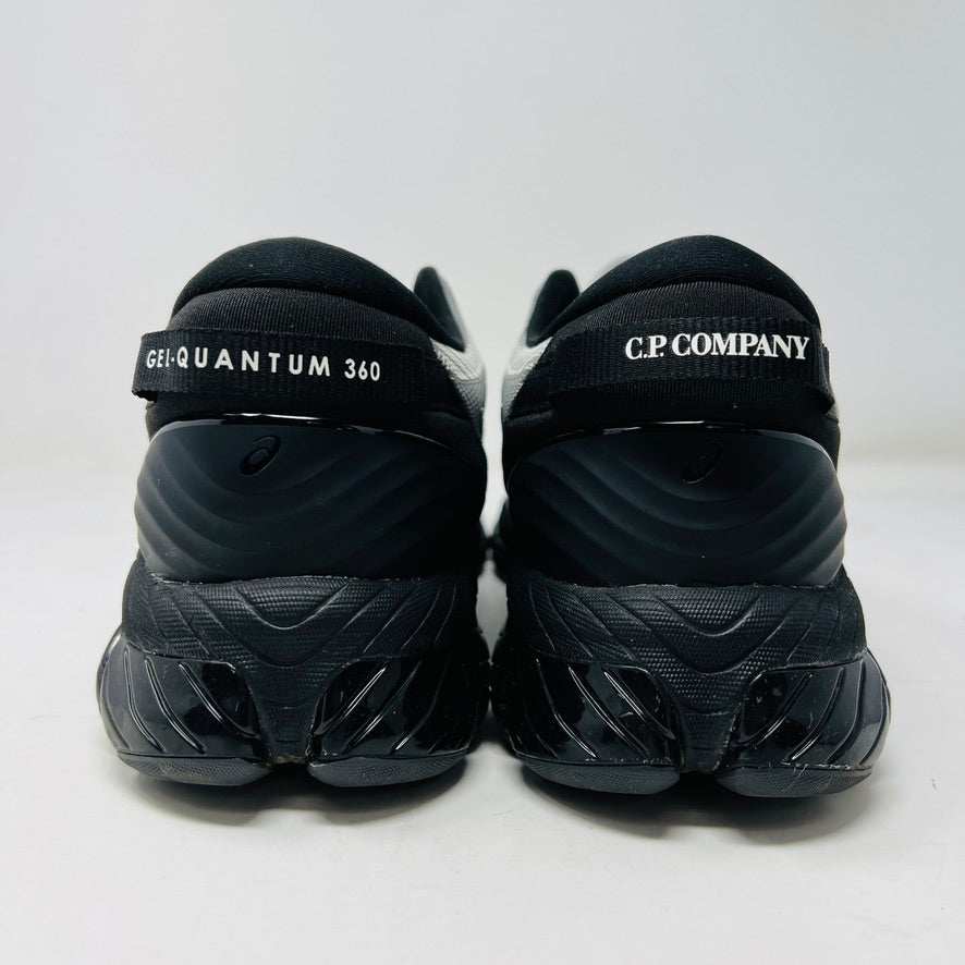 A side view of the ASICS Gel-Quantum 360 VIII C.P. Company in Cement Grey, featuring a sleek modern design with gray and silver elements, black accents, a black sole, and subtle patterns on its clean upper. The background is plain white.