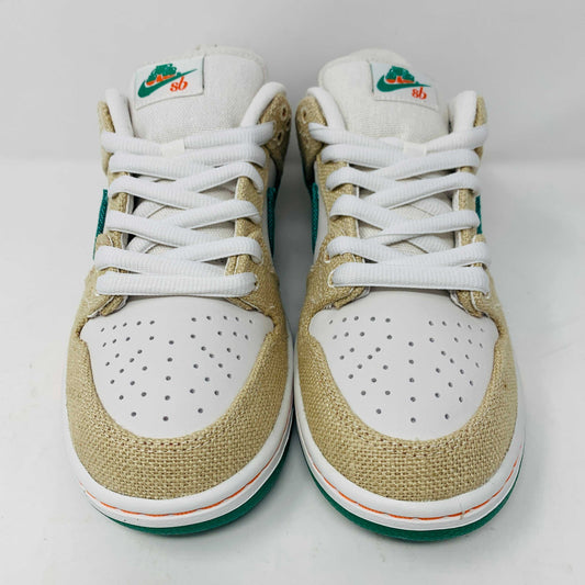 Front view of a brand new pair of Nike SB Dunk Low Jarritos sneakers in beige and white with green accents, featuring textured beige material, perforated toe panels, white laces, and swoosh logos on the tongues. Extra 2 laces included; displayed on a plain white background.