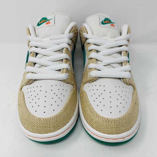 Front view of a brand new pair of Nike SB Dunk Low Jarritos sneakers in beige and white with green accents, featuring textured beige material, perforated toe panels, white laces, and swoosh logos on the tongues. Extra 2 laces included; displayed on a plain white background.