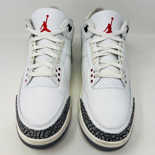Jordan 3 Retro White Cement sneakers on Nike box, 2023 edition.