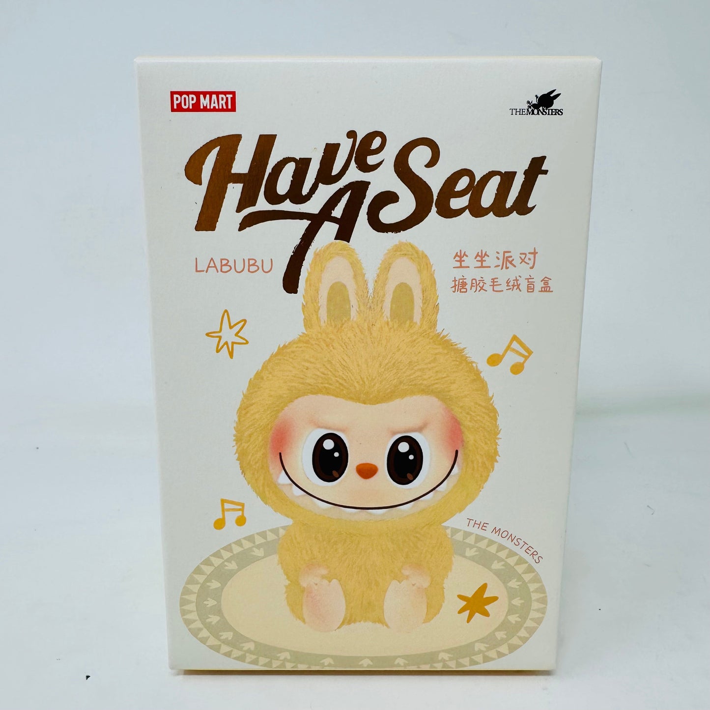 Pop Mart Have A Seat Labubu blind box packaging featuring cute character illustration.