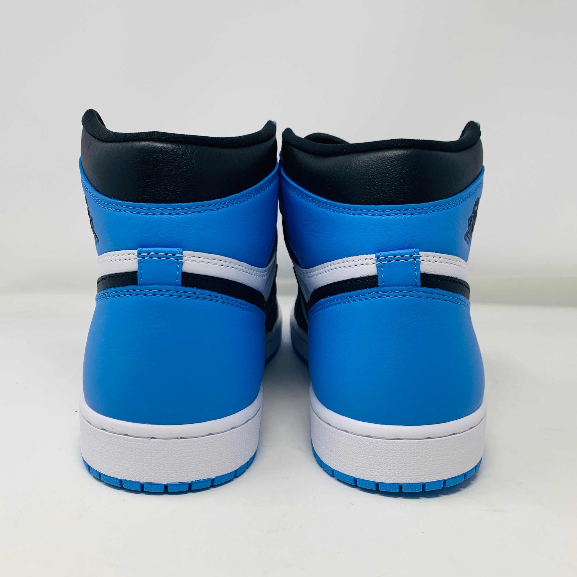 Jordan 1 High UNC Toe sneaker, white and blue colorway, rear view.