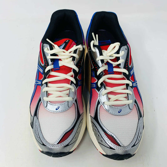 The ASICS GT-2160 Kith Marvel Villains Spider-Man/Venom Battle Spectra Pack is shown on a gray shoebox, featuring vibrant pink, blue, and white details. Its 100% authentic and brand new. Three sets of shoelaces in white, red, and blue are included in plastic bags next to the box.