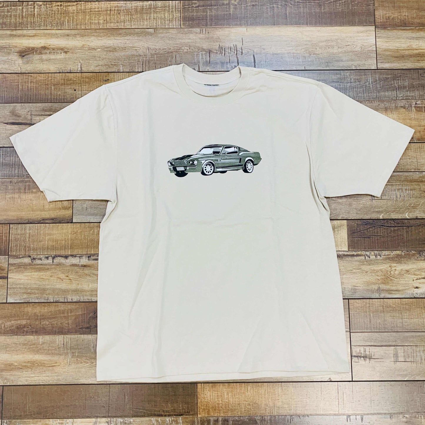 Holy Ground Mustang Tee Sand with car graphic, sizes S-XL available.