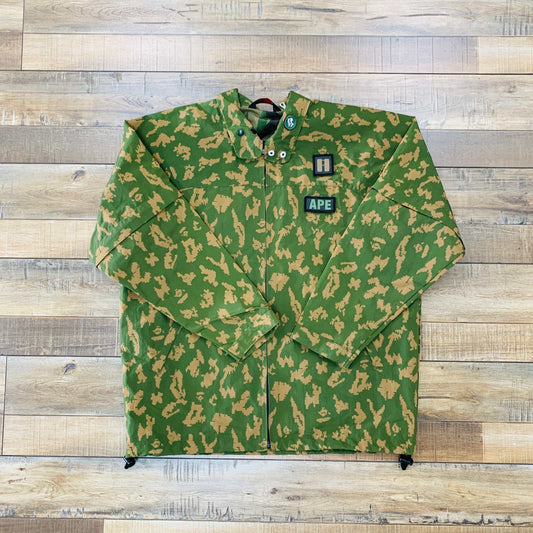 Bape Ape Military Camo Jacket, preowned, medium size, green camo pattern on wooden background.