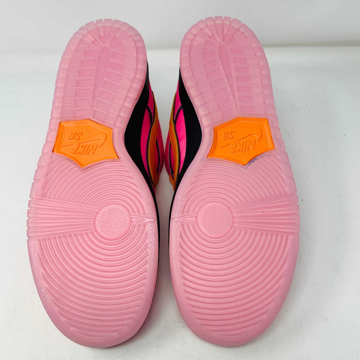 Nike SB Dunk Low The Powerpuff Girls Blossom sneaker with pink, green, and black colorway, displayed on a box.