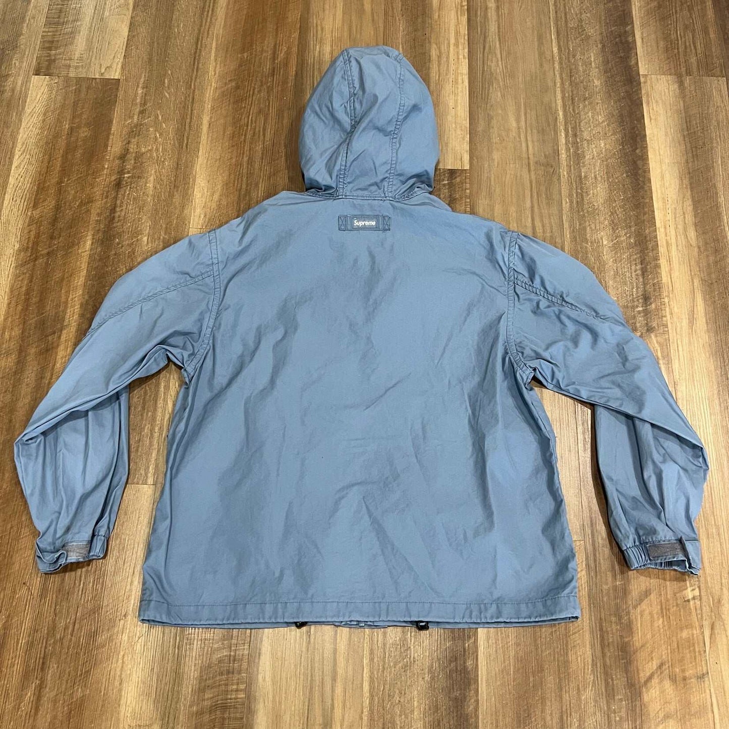 Supreme Mesh Pocket Cargo Jacket Slate, preowned, hooded design on wooden floor.