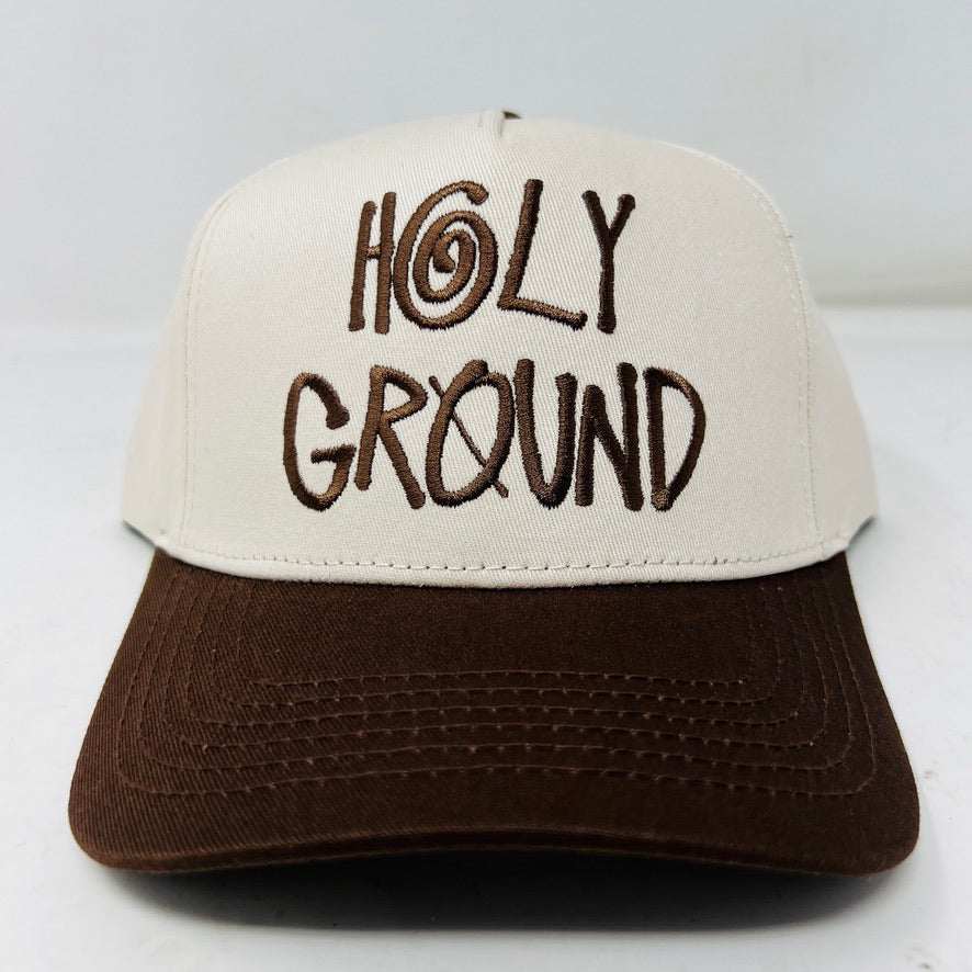 The Holy Ground Stussy Hat by Holy Ground is a streetwear accessory with HOLY GROUND embroidered in black on its white front panel, complemented by a green bill for a fresh touch.