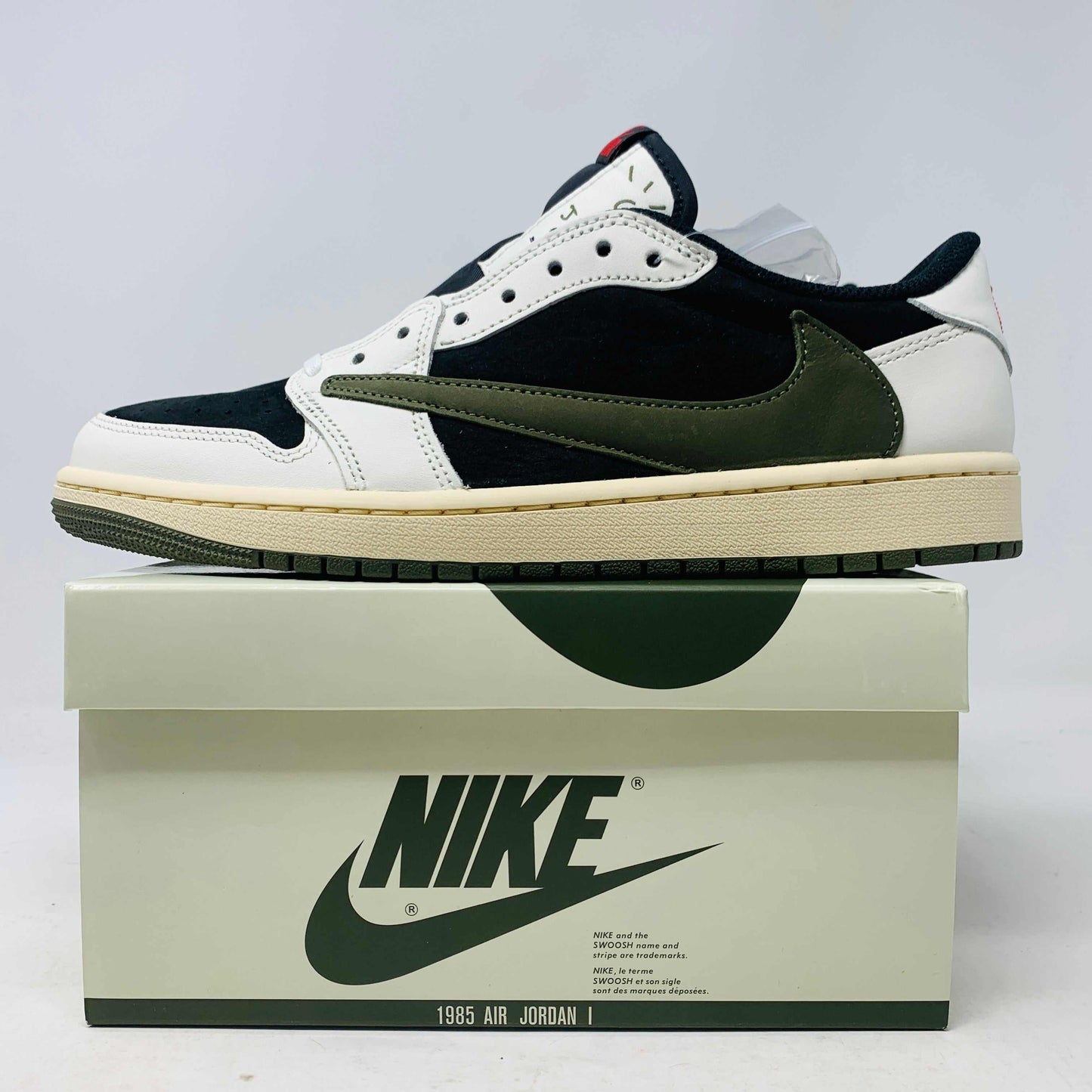 Jordan 1 Retro Low OG SP Travis Scott Olive sneaker with Nike box.