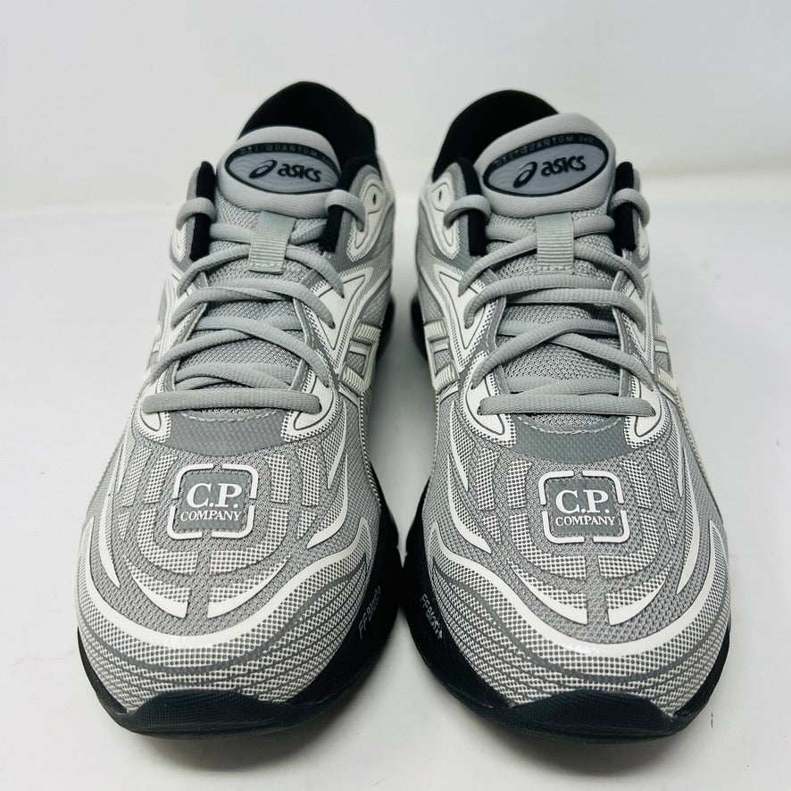 A side view of the ASICS Gel-Quantum 360 VIII C.P. Company in Cement Grey, featuring a sleek modern design with gray and silver elements, black accents, a black sole, and subtle patterns on its clean upper. The background is plain white.