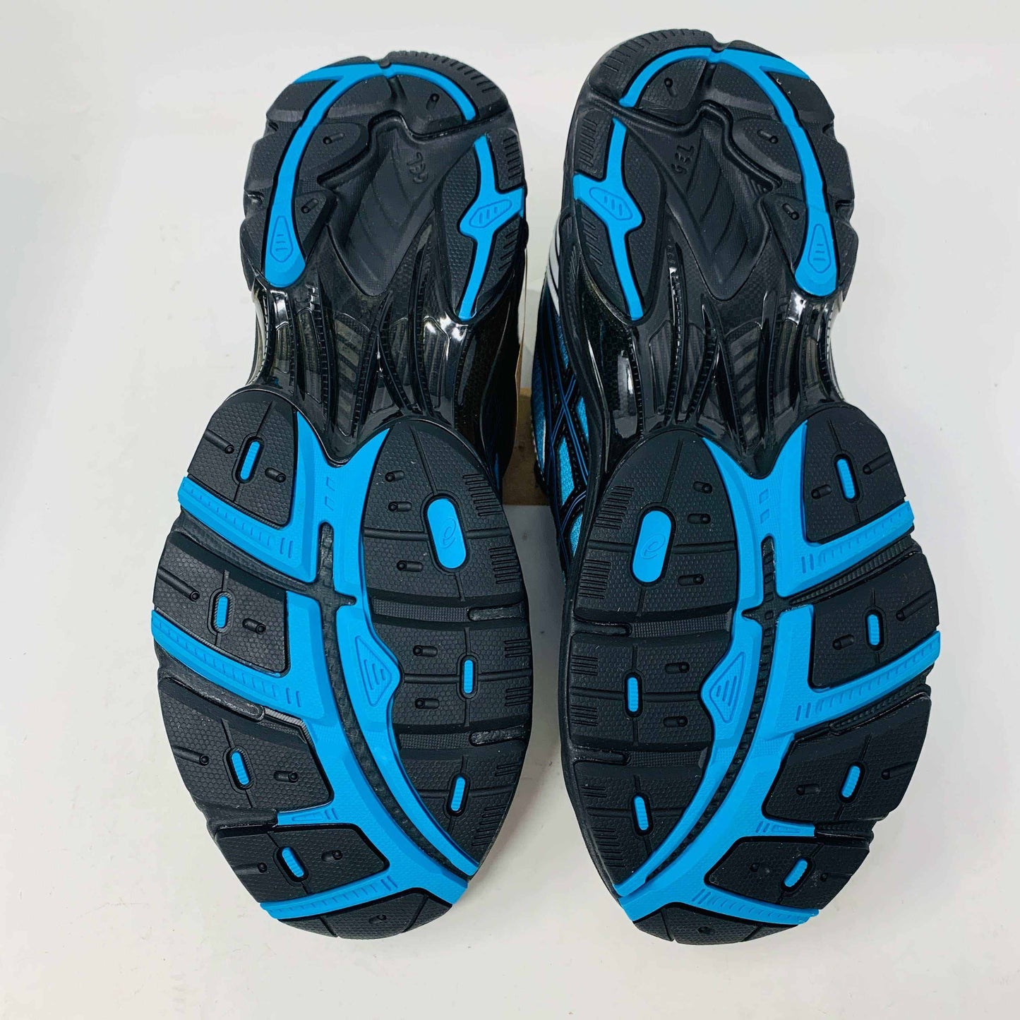 The ASICS GT-2160 Kith Marvel Villains Spider-Man/Venom Battle Spectra Pack is shown on a gray shoebox, featuring vibrant pink, blue, and white details. Its 100% authentic and brand new. Three sets of shoelaces in white, red, and blue are included in plastic bags next to the box.