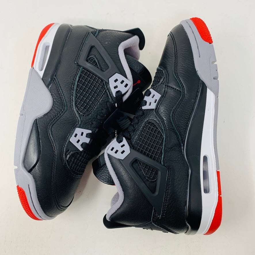 Jordan 4 Retro Bred Reimagined (GS) sneakers, black and red, leather and mesh upper, Jumpman logo, Air-Sole cushioning.