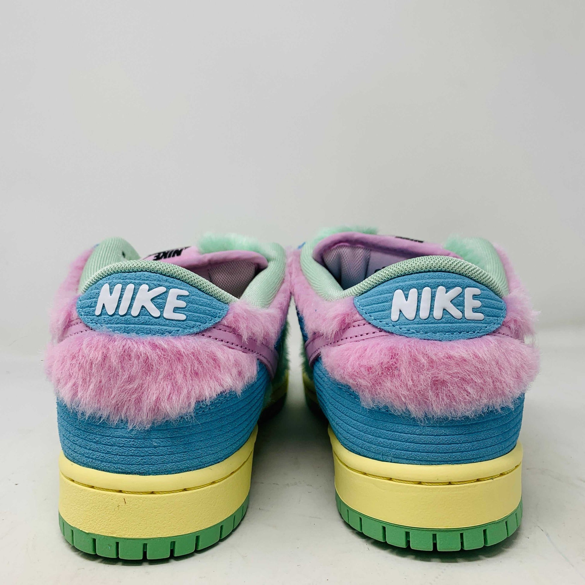 The Nike SB Dunk Low Verdy Visty sneakers are vibrant new additions for 2024, featuring blue, pink, and green accents, a fluffy collar texture, a bright yellow sole, and the iconic white Nike logo on the back.